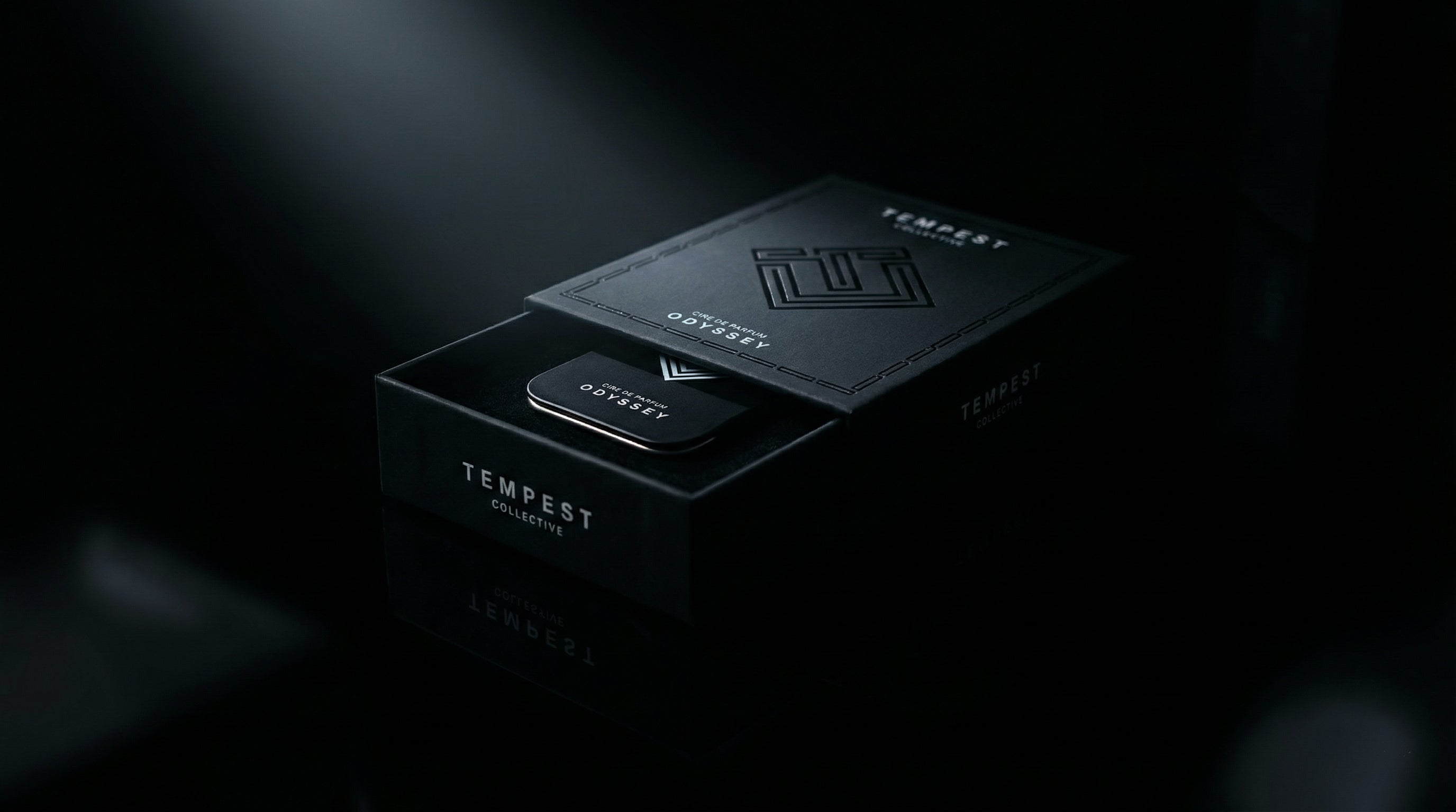 Black 'Tempest Collective' Box and Tin packaging on a dark background